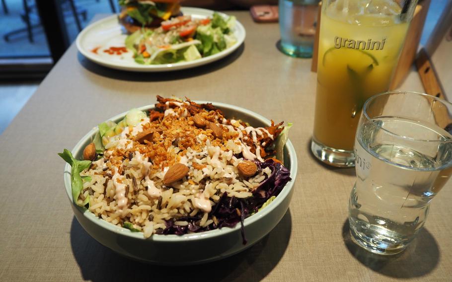 In the foreground is the Tiger Bowl and pina y gato, a coconut, pineapple and mint lemonade, and in the background is the “Cheezeburger” from the Katzentempel restaurant in Trier, Germany, on June 8, 2024.