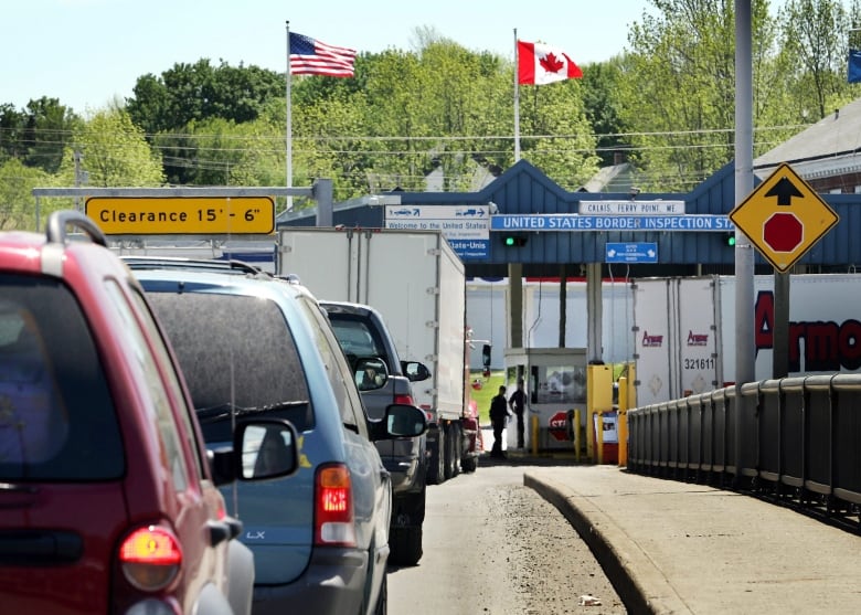 A line of cars heading towards a small border station in Calais