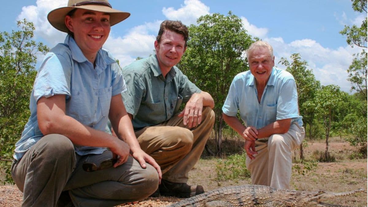 Adam Britton (centre) with David Attenborough (right) and his wife Erin (left) during filming for a BBC documentary. X